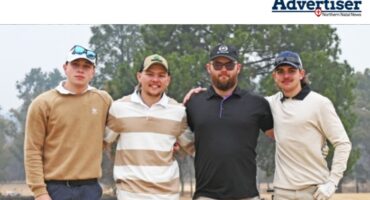 A group photo of several golf players posing on the greens in Newcastle.