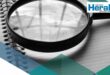 Image of a report under a magnifying glass.