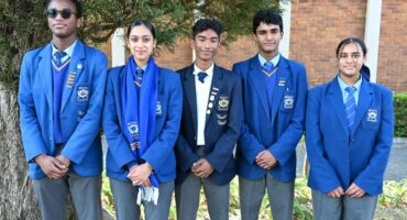 Image of top learners from Sarel Cilliers High School in uniform standing next to each other.