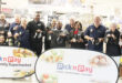 Image of Dundee Rotarians and Dundee Pick n Pay staff holding shoes for needy learners.