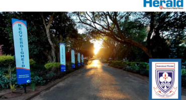 Image of Hoërskool Pionier's entry road to the school with emblem.