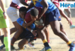 Image of a Vryheid rugby player trying to break through a defence.