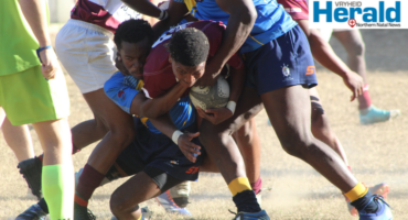 Image of a Vryheid rugby player trying to break through a defence.