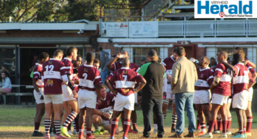Image of Vryheid's rugby players gathering in a circle with coaches.