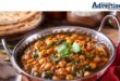 A photo of several bowls of various foods used in a curry dish.