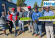 An image of Zakhele Xulu alongside various stakeholders who launched the One Home, One Garden initiative during Mandela Day; 67 minutes in Hlobane.