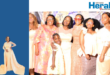 An image of Thandeka Sibisi who is the founder of Midnight watchers posing with some of the attendees of an annual conference that was held at King Shenge Village.
