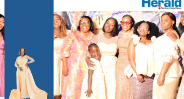 An image of Thandeka Sibisi who is the founder of Midnight watchers posing with some of the attendees of an annual conference that was held at King Shenge Village.