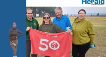 Image of parkrunners holding a 50th event banner.