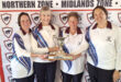 Photo of four lady members of the Dundee Bowling Club standing shoulder to shoulder with a trophy.