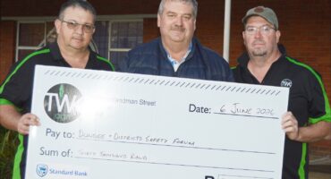 Image of three men holding a large cheque donation that went towards rural safety in the Dundee area.