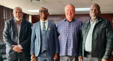KZN Finance MEC Francois Rodgers with Endumeni Councillors, Salem Abdool, Mayor Mcebo Mkhize and Zitha Shelembe standing shoulder to shoulder.