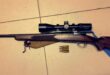Image of a hunting rifle with scope and ammunition.