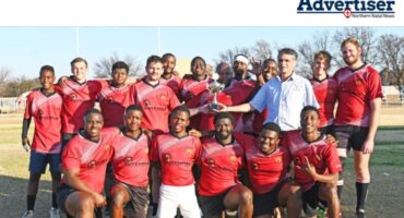 Chairman of the Boshckpick Newcastle Highlanders Rugby Club, Alistair van Wyk, presents the NRSU League trophy to the Newcastle Highlanders' third team.
