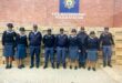 SAPS members in uniform standing outside the KwaNocomboshe Police Station