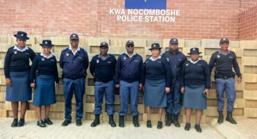 SAPS members in uniform standing outside the KwaNocomboshe Police Station