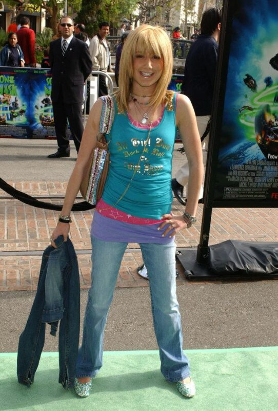 A young celebrity is photographed at a red carpet event.