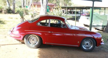 Image of a vintage red Porsche car at Talana Museum,