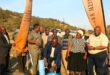 Image of people launching a water project but turning a sod.