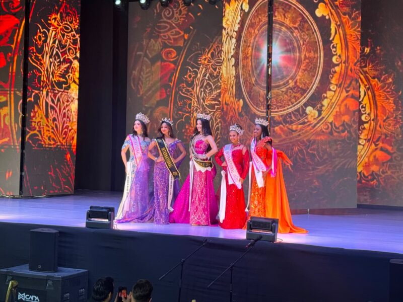 A photo of several pageant contestants on stage.