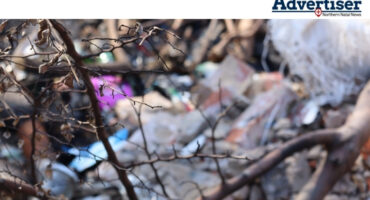 A photograph of litter dumped in an open field in Newcastle.