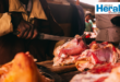 Image of a hand with a knife cutting meat.