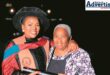 A photo taken of two women. One is an elderly woman and the other is a younger graduate.
