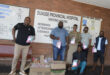 Image of men giving out Women's Day packages at Dundee Hospital.