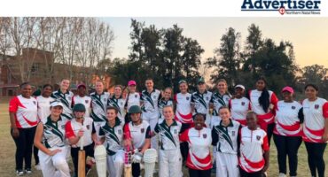A large group photo taken of female cricket players.