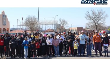 A large group of children and their parents get ready to run.