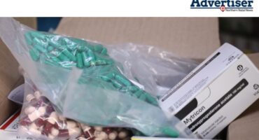 A photo of a brown box filled with various medications.