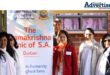 Dr Shivani Singh with members of the Ramakrishna Centre pose infront of a banner.
