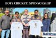 A photo of a group of people holding up new T-Shirts sponsord to the NHS 1st team Cricket.