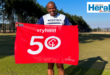 Image of runner holding 50th milestone parkrun flag.