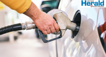 Image of hand pouring petrol into a car.