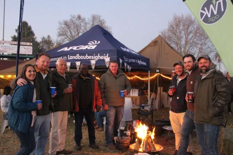 Image of people standing around a fire during festivities.