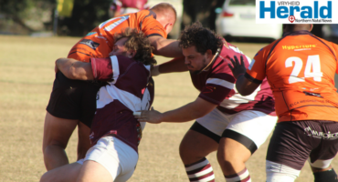 Image of a rugby player tackling another player.
