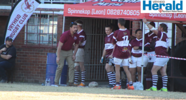 Image of Vryheid Rugby Club coach speaking to players on the bench.