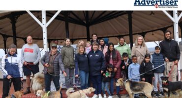 A photo taken of a large group of people with their dogs at St Dominics Newcastle School.