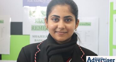 A portrait photo of a learner during a science fair.