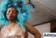 A young model is pictured with blue hair on the runway.