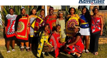 A group photo of school children dressed in traditional Zulu attire.