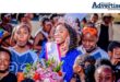 A group photo of supporters welcoming home a young beauty pageant contestant.
