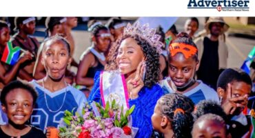 A group photo of supporters welcoming home a young beauty pageant contestant.
