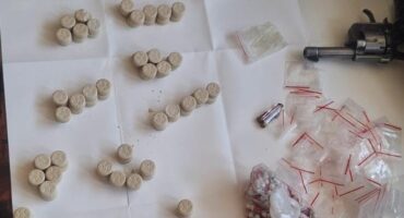 Image of confiscated tablets of narcotics on a table.