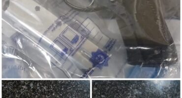 Image of firearms and ammunition in evidence bags.