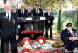 Image of MOTH members in front of the Dundee Shellhole Memorial Wall in uniform.