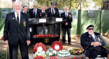 Image of MOTH members in front of the Dundee Shellhole Memorial Wall in uniform.