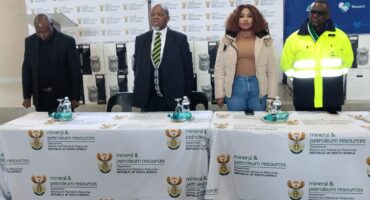 Image of Dannhauser Mayor Bongane Rade with Mineral & Petroleum Resources Minister Gwede Mantashe in Ward 2, accompanied by Deputy Minister Phumzile Sinclaire Mgcina and local councillors standing behind a table.