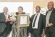 Image of the Dannhauser Primary principal receiving a certificate from national education officials.